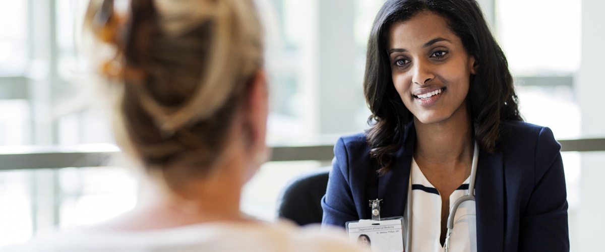 Photo of a health professional speaking with a patient