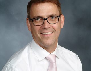 Portrait of Dr. Ole Vielemeyer, infectious disease specialist who gives tips on how to stay healthy while traveling.