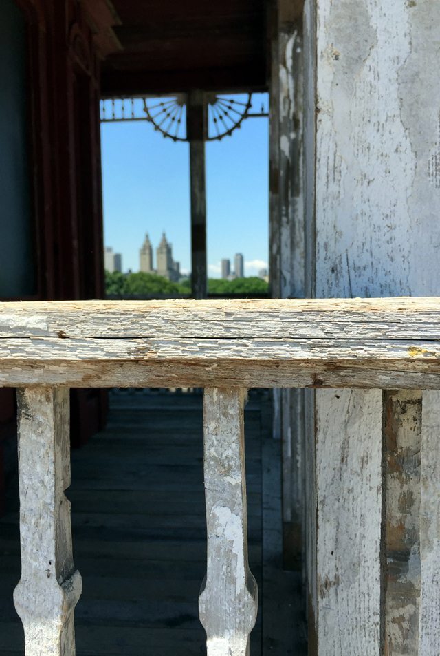 A photo of a window reflecting a cityscape
