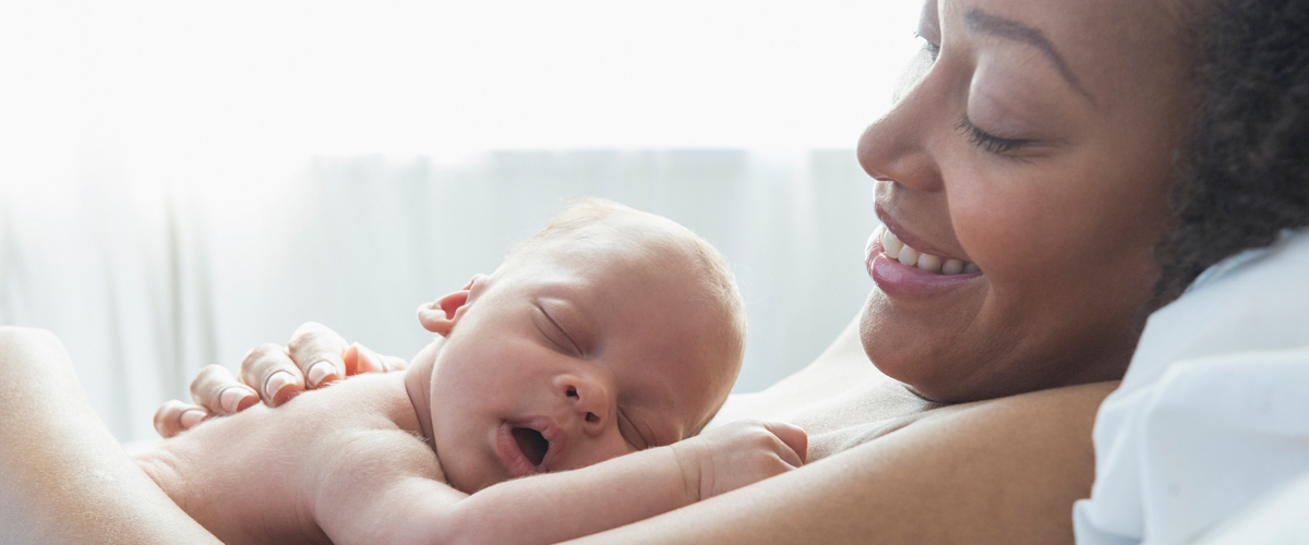 A woman cradling a newborn