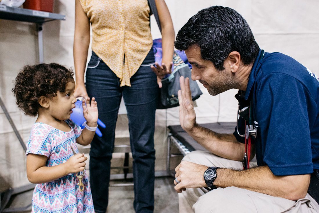 Dr. Chris Tedeschi with a young patient in a federal medical shelter in Puerto Rico