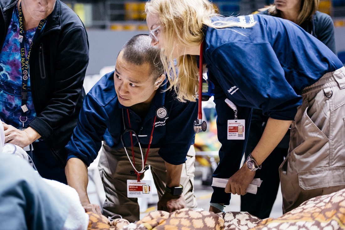 Healthcare providers tending to a patient in a federal medical shelter in Puerto Rico