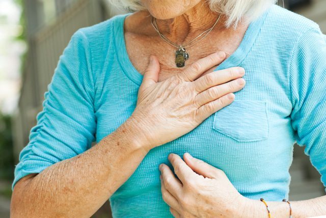 A woman clutching her chest