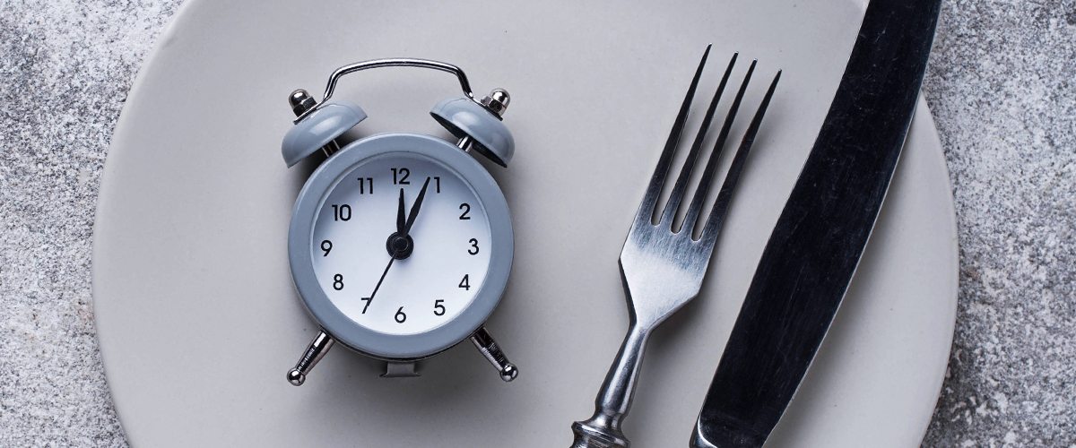 A knife, fork and clock on a plate
