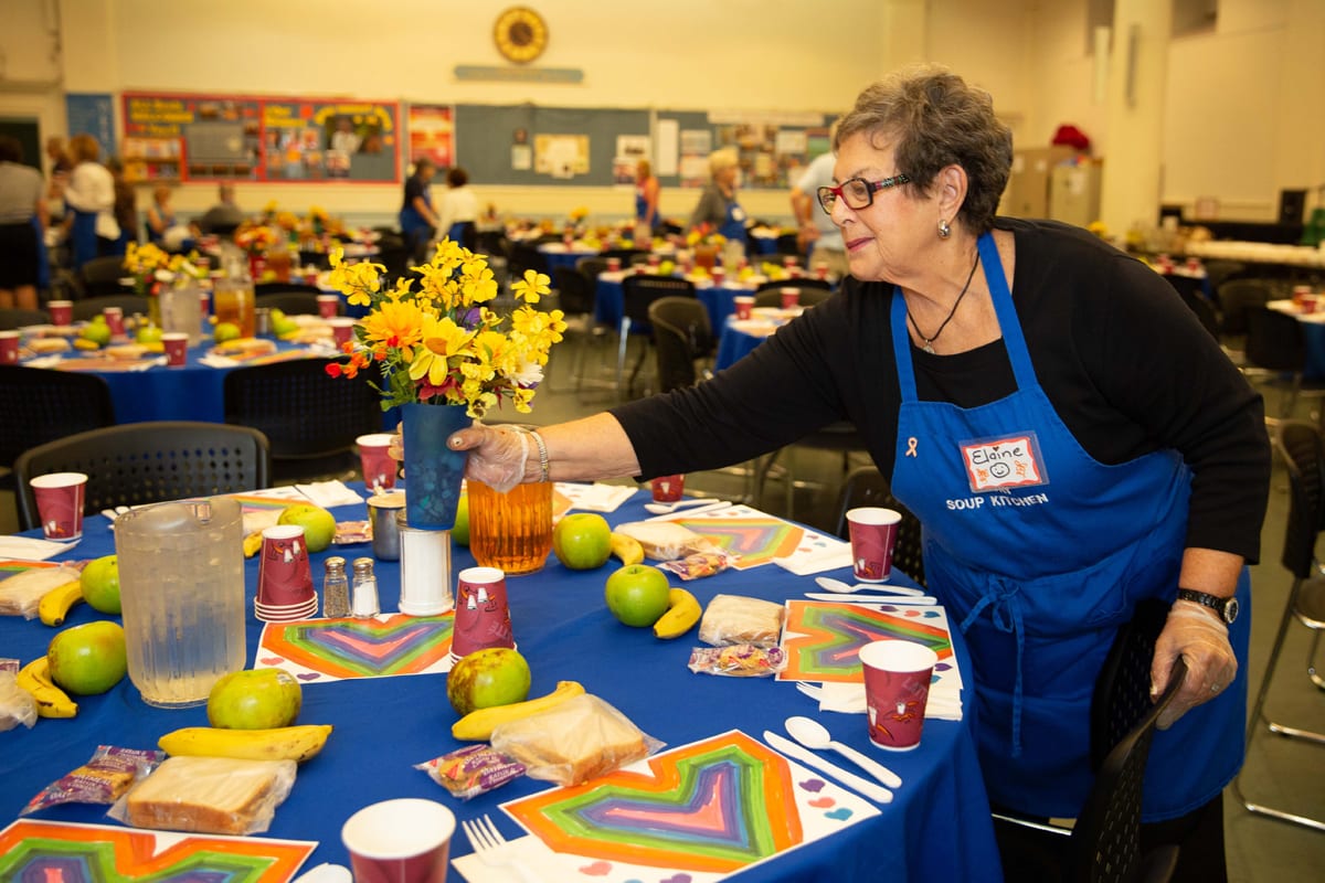 A woman volunteering at a soup kitchen