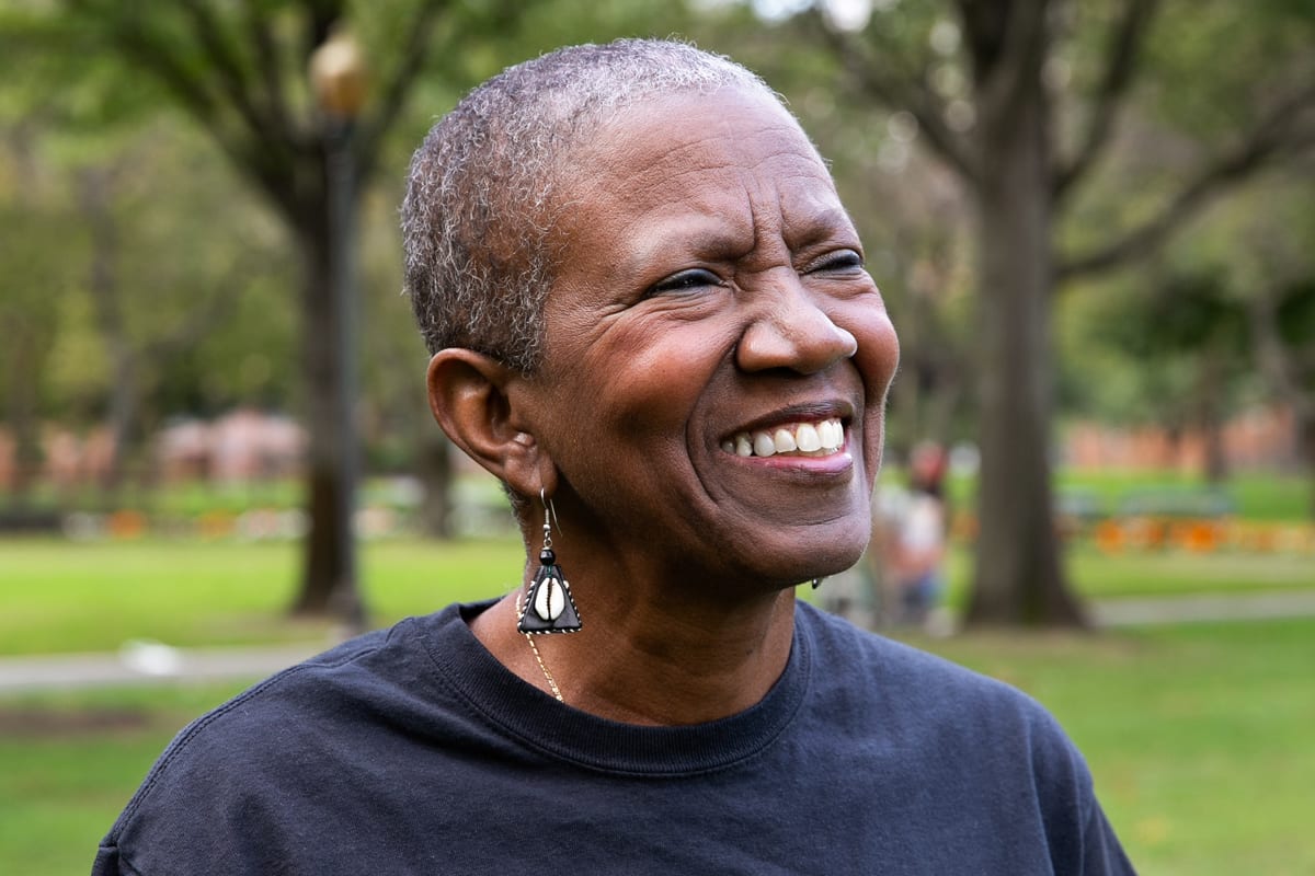 A woman smiling in a park