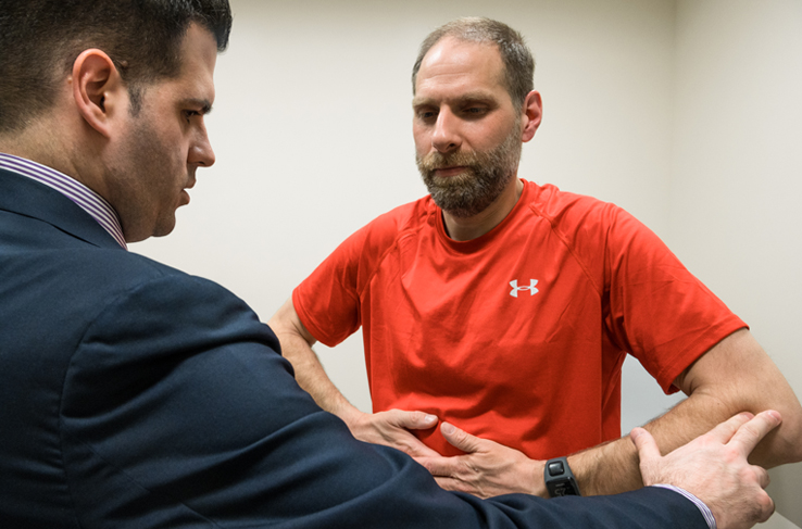 A man being evaluated by a healthcare provider