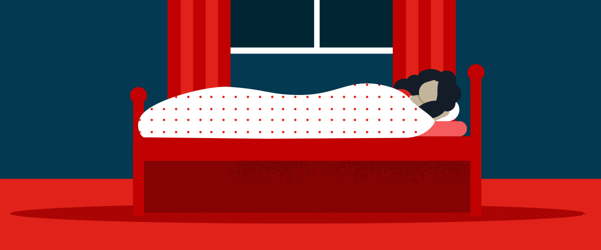 Woman sleeping on bed to try the benefits of a weighted blanket