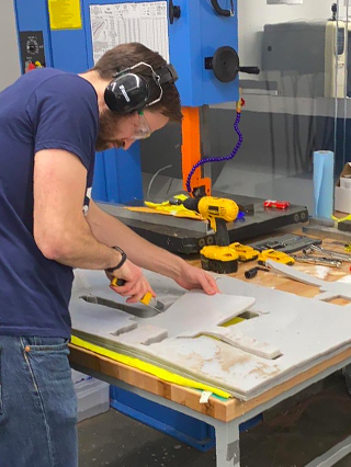 Yevgeniy Yesilevskiy preparing the face shields for packing in the Makerspace at Columbia University’s Engineering School.