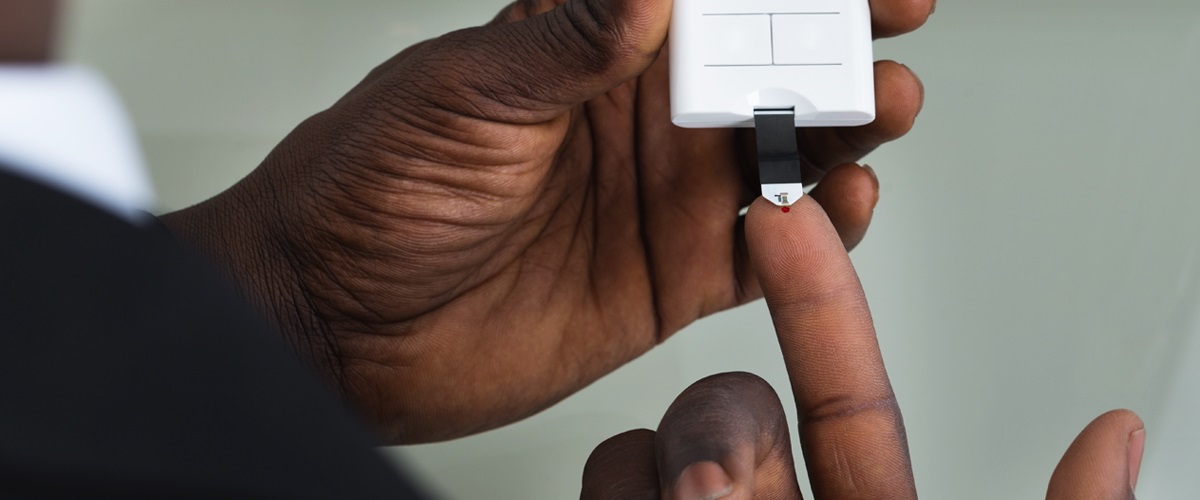 A person with diabetes uses a device to check blood sugar