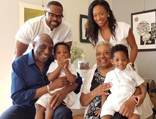 A smiling family with two young children