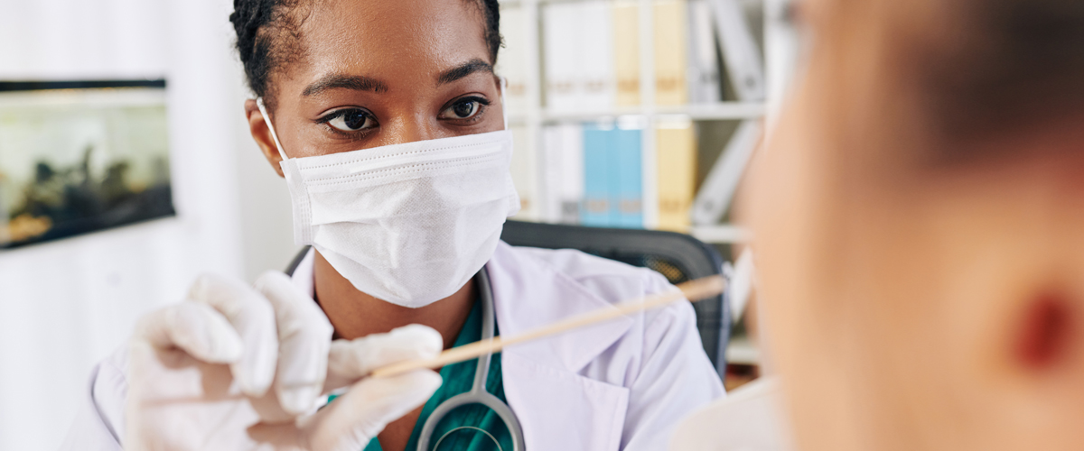 Woman administers COVID test. How accurate are COVID test results?
